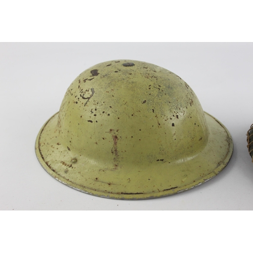 499 - Two vintage military steel helmets