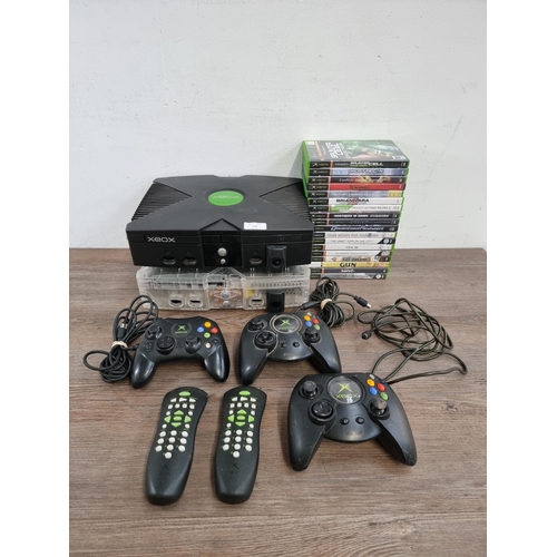 562 - Two Microsoft Xbox original games consoles with one S and two Duke controllers, two DVD remotes and ... 