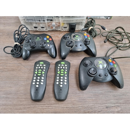 562 - Two Microsoft Xbox original games consoles with one S and two Duke controllers, two DVD remotes and ... 