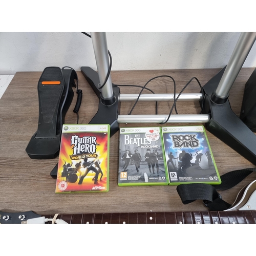 573 - A Microsoft Xbox 360 Elite games console with three games, Rock Band drum set, two microphones and o... 