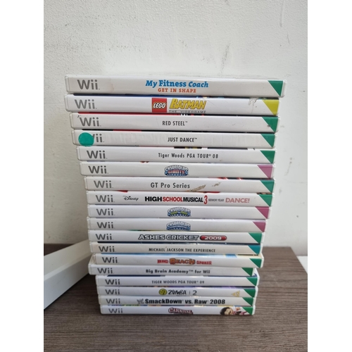 575 - A Nintendo Wii U games console with Wii fit board, eighteen Wii games, Rock Band drum set and a larg... 