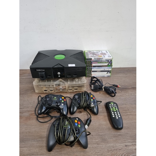 576 - Two Microsoft Xbox Original games consoles with three controllers, one Duke, two S and eleven games