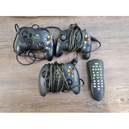 576 - Two Microsoft Xbox Original games consoles with three controllers, one Duke, two S and eleven games