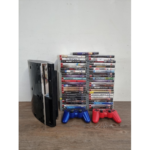 578 - A Sony PlayStation 3 CECHCO3 backwards compatible games console with two controllers and forty-nine ... 