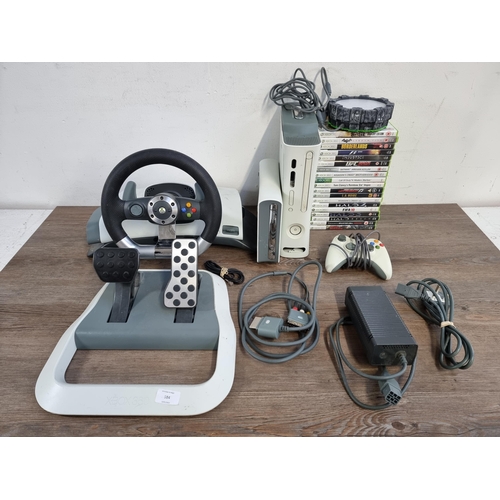 584 - A Microsoft Xbox 360 games console with accessories to include official Microsoft steering wheel and... 