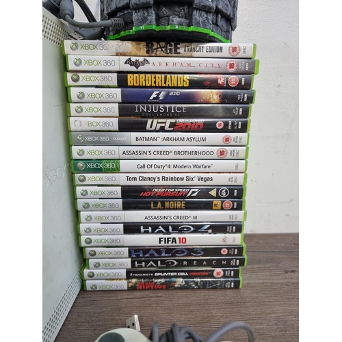 584 - A Microsoft Xbox 360 games console with accessories to include official Microsoft steering wheel and... 