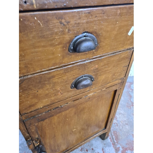 171 - An early/mid 20th century pine tool cabinet containing vintage hand tools and mounted with cast iron... 