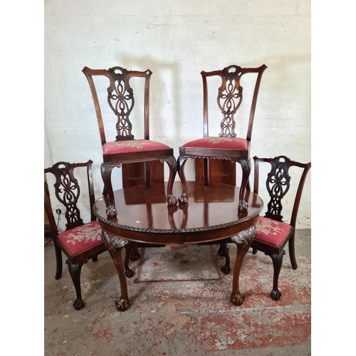 137 - A Georgian style mahogany wind out extending dining table with ball and claw supports, four dining c... 