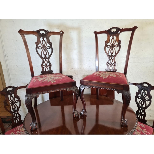 137 - A Georgian style mahogany wind out extending dining table with ball and claw supports, four dining c... 