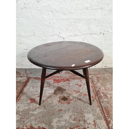 144 - An Ercol dark elm and beech drop leaf gate leg circular side table - approx. 47cm high x 61cm diamet... 