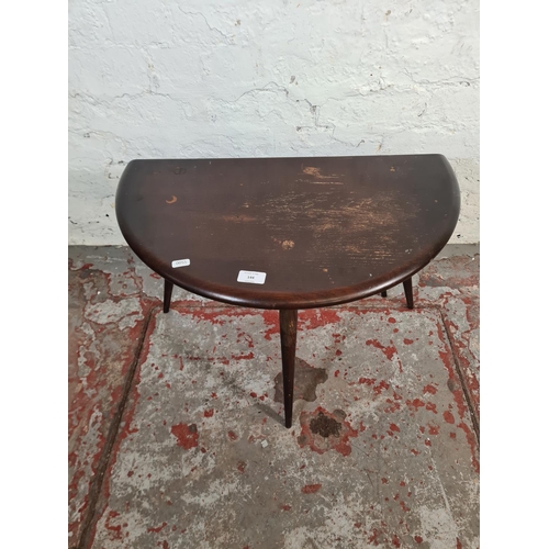 144 - An Ercol dark elm and beech drop leaf gate leg circular side table - approx. 47cm high x 61cm diamet... 