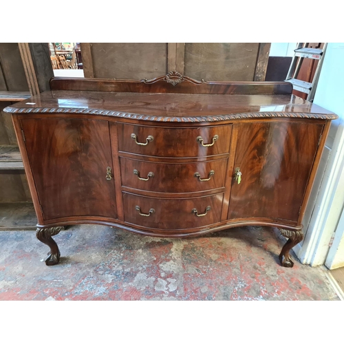 156 - A Georgian style mahogany bow fronted sideboard with three central drawers, two outer cupboard doors... 