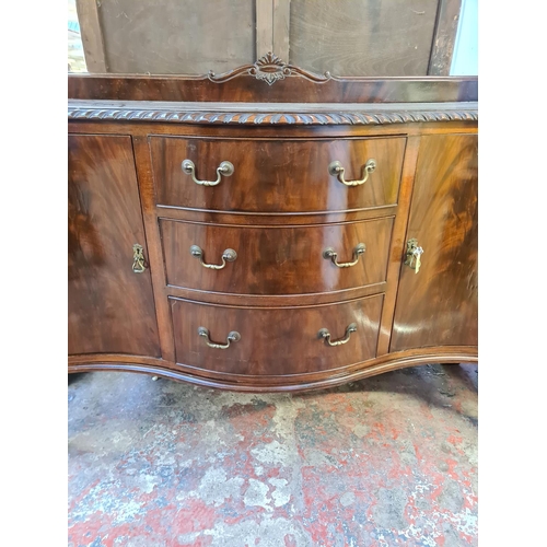 156 - A Georgian style mahogany bow fronted sideboard with three central drawers, two outer cupboard doors... 