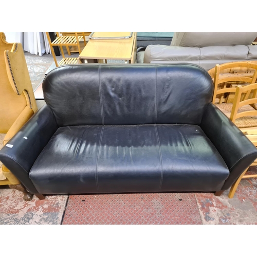 168 - A modern black leatherette three seater sofa