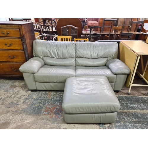 178 - A modern grey leather three seater sofa and matching storage footstool