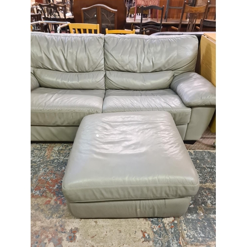 178 - A modern grey leather three seater sofa and matching storage footstool