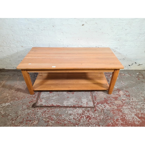 196 - A modern solid oak rectangular two tier coffee table - approx. 46cm high x 60cm wide x 120cm long