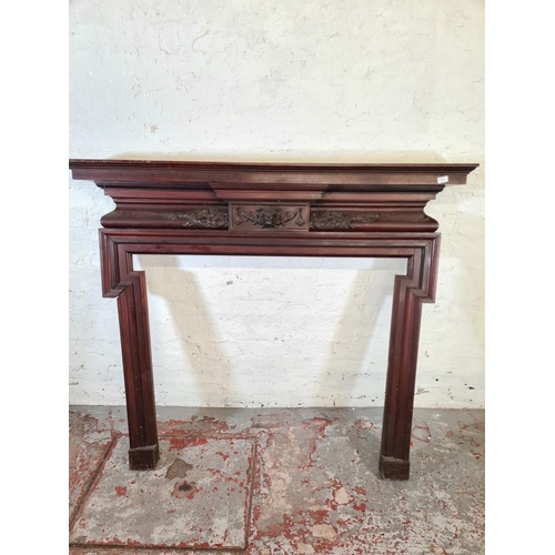 206 - A Victorian carved mahogany fire surround with lion face design - approx. 140cm high x 160cm wide x ... 