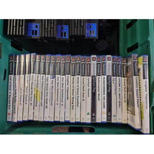 601 - Three Sony PlayStation 2 games consoles with accessories and games