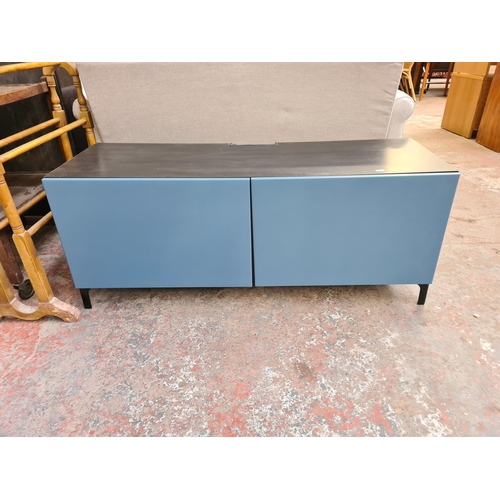 125A - A modern black ash effect and blue painted two door TV cabinet - approx. 48cm high x 120cm wide x 42... 