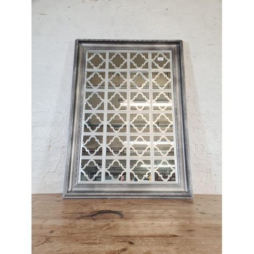 213 - A modern framed wall mirror with Arabesque overlay - approx. 106cm high x 75cm wide