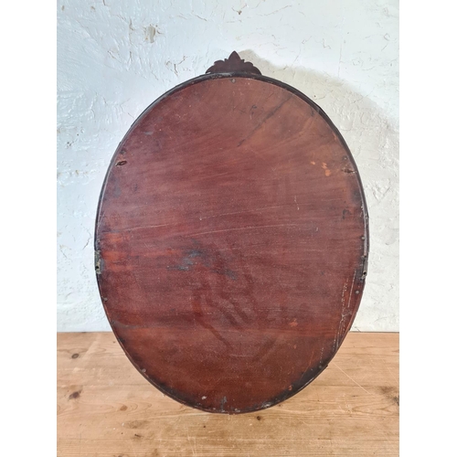 218 - A late 19th/early 20th century mahogany framed oval wall mirror - approx. 70cm high x 50cm wide