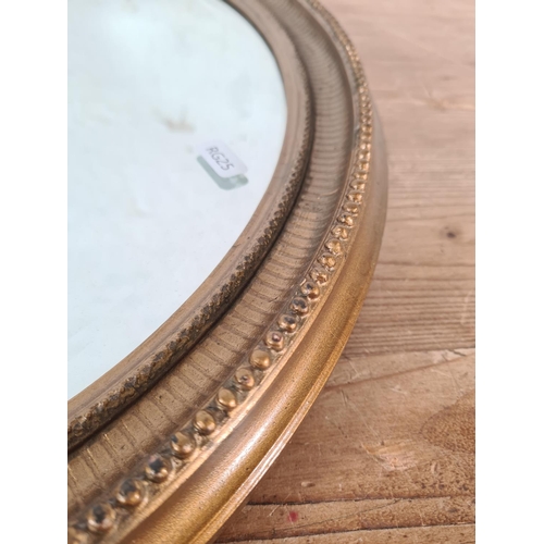 219 - A Regency style gilt framed bevelled edge oval wall mirror - approx. 52cm high x 41cm wide