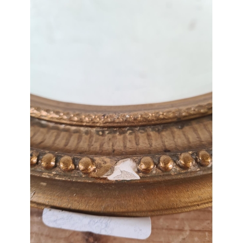 219 - A Regency style gilt framed bevelled edge oval wall mirror - approx. 52cm high x 41cm wide