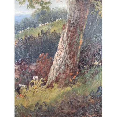 226 - A gilt framed oil on canvas of a woodland scene, signed lower left - approx. 55cm high x 45cm wide