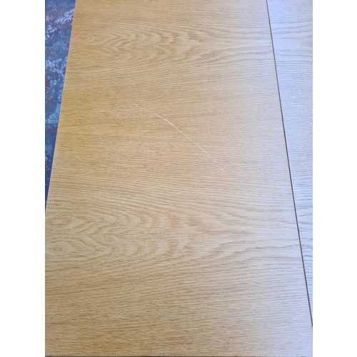 24 - A modern oak drop leaf dining table - approx. 73cm high x 85cm wide x 222cm long