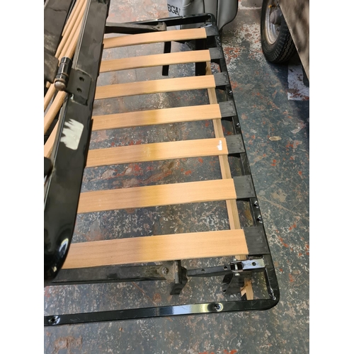 812 - A cast metal and wooden slatted folding rock and roll bed for campervan conversions