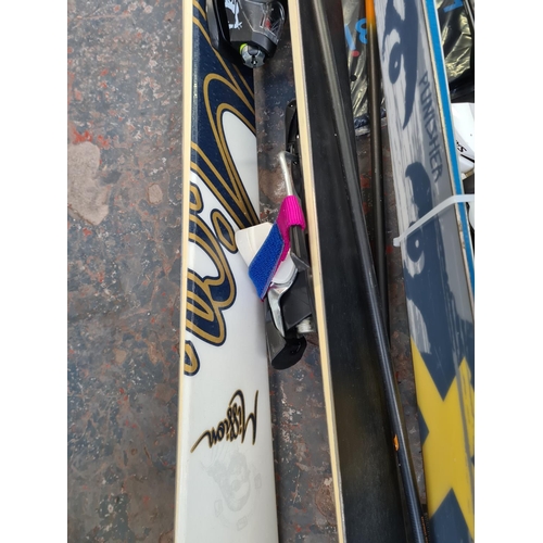 819 - A collection of skiing equipment to include two pairs of Scott skis, pair of Salomon Quest size 26 s... 