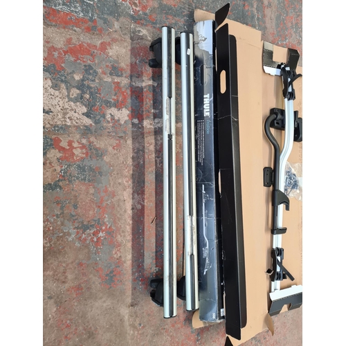 828 - Two boxed Thule ProRide 598 bike carriers and a pair of roof bars