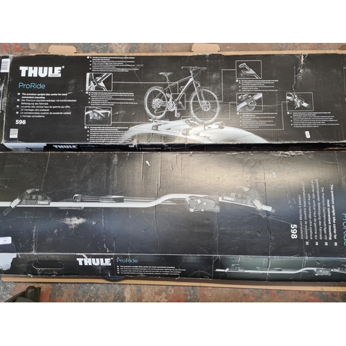 828 - Two boxed Thule ProRide 598 bike carriers and a pair of roof bars