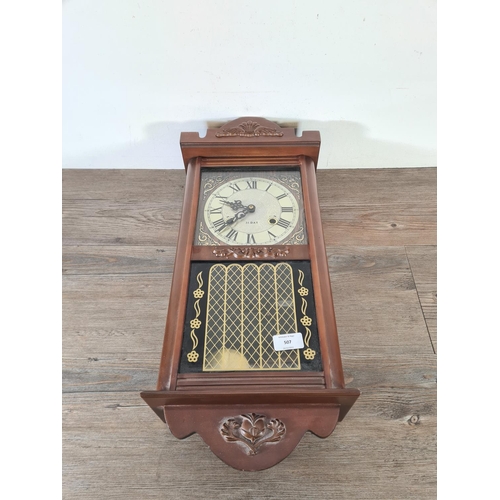 490 - A mid 20th century mahogany effect cased thirty one day chiming wall clock with pendulum and key - a... 