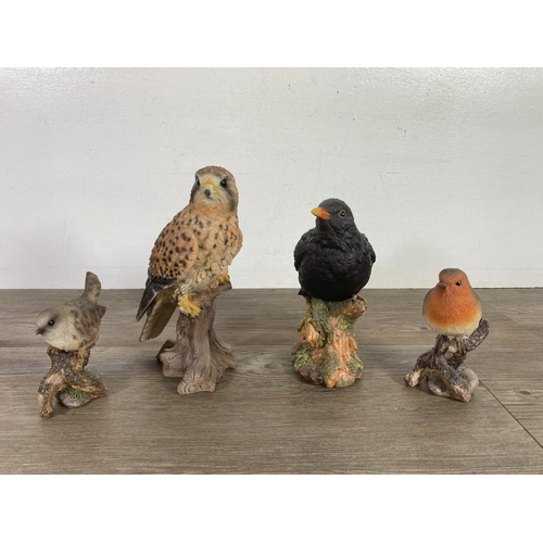 334 - Nine resin bird figurines to include Vivid Arts etc .