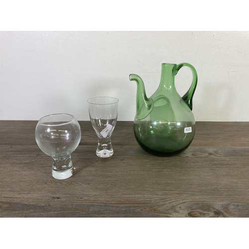 345 - A collection of glassware to include three decanters, green glass hand blown decanter etc.