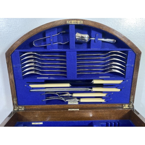 355 - A 1920s Walker & Hall oak presentation canteen of cutlery - presented by the directors and staff of ... 