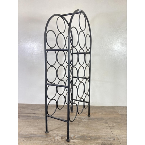 356 - A wrought iron sixteen section bottle rack - approx. 69cm high x 32cm wide x 15cm deep