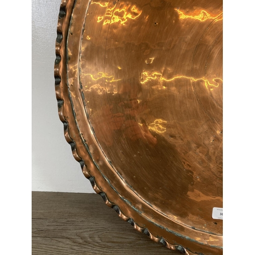 366 - A large copper pie crust edge charger - approx. 65cm diameter