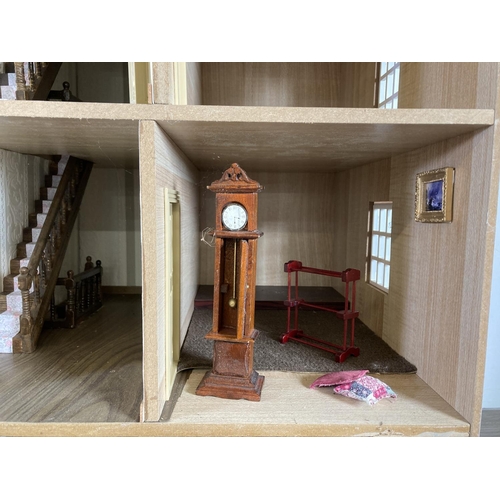 393 - A Georgian style three storey doll’s house with furniture and accessories - approx. 86cm high x 73cm... 