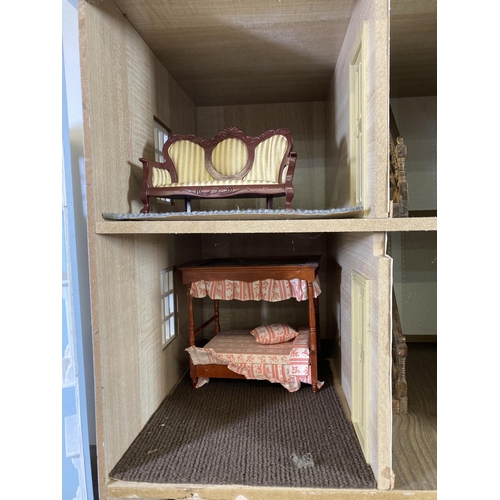 393 - A Georgian style three storey doll’s house with furniture and accessories - approx. 86cm high x 73cm... 