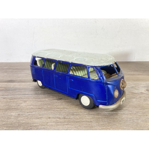 406 - Two mid 20th century tinplate model vehicles, one VW camper van made in Japan and one clockwork ToyT... 