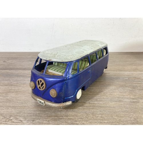 406 - Two mid 20th century tinplate model vehicles, one VW camper van made in Japan and one clockwork ToyT... 