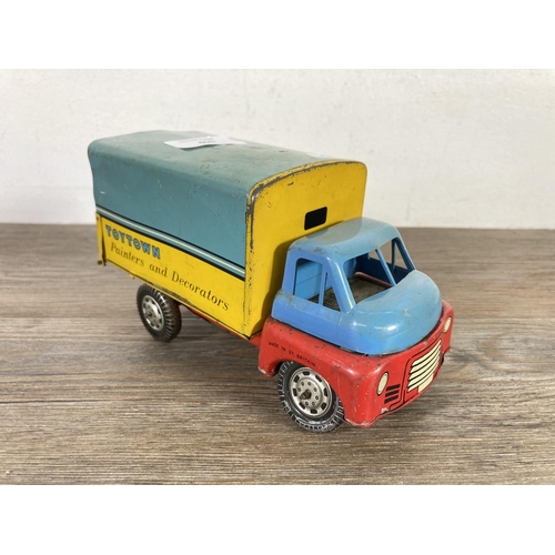 406 - Two mid 20th century tinplate model vehicles, one VW camper van made in Japan and one clockwork ToyT... 