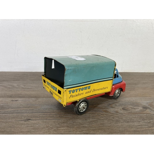 406 - Two mid 20th century tinplate model vehicles, one VW camper van made in Japan and one clockwork ToyT... 