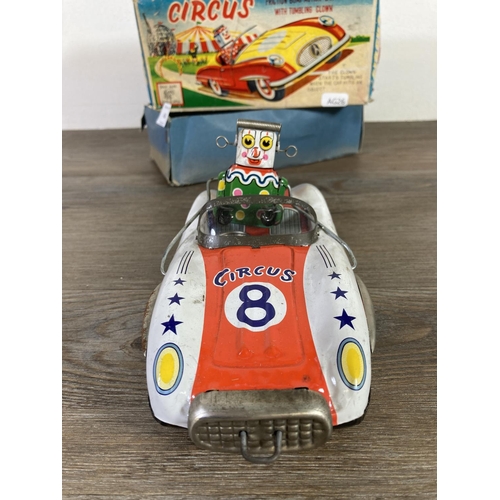 410 - A boxed ATC tinplate circus friction bump action model car with tumbling clown