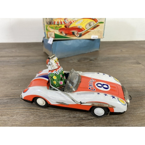 410 - A boxed ATC tinplate circus friction bump action model car with tumbling clown