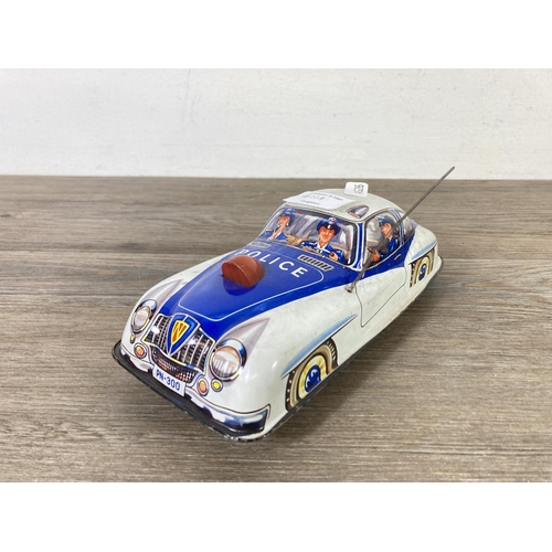 411A - Two mid 20th century tinplate model police cars to include PN-300 etc.