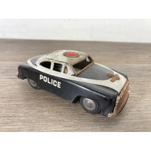 411A - Two mid 20th century tinplate model police cars to include PN-300 etc.